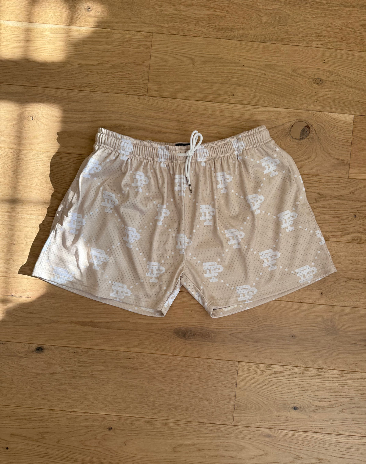 Butter monogram shorts